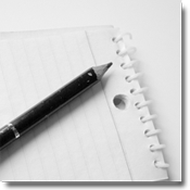 a pencil on an empty notebook